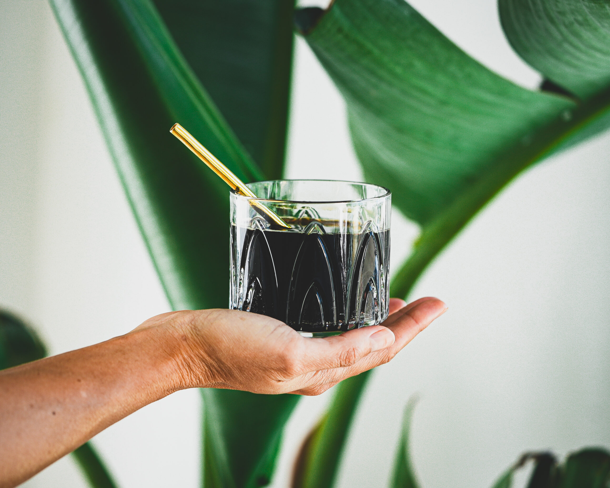 Ecolux Sipper held out in a cup
